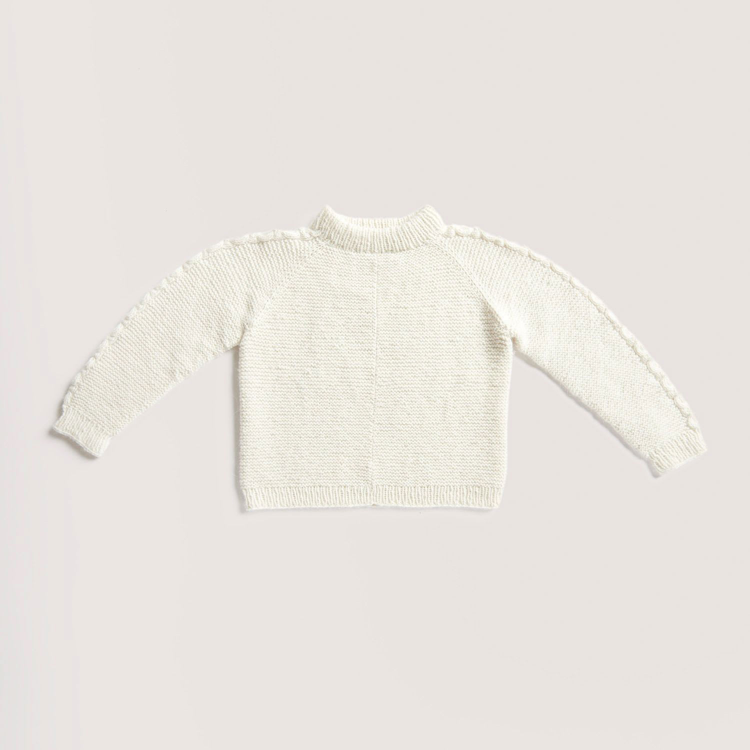 Rico Design Soft Alpaca Yarn - Cream, 137 yds showing completed sweater project