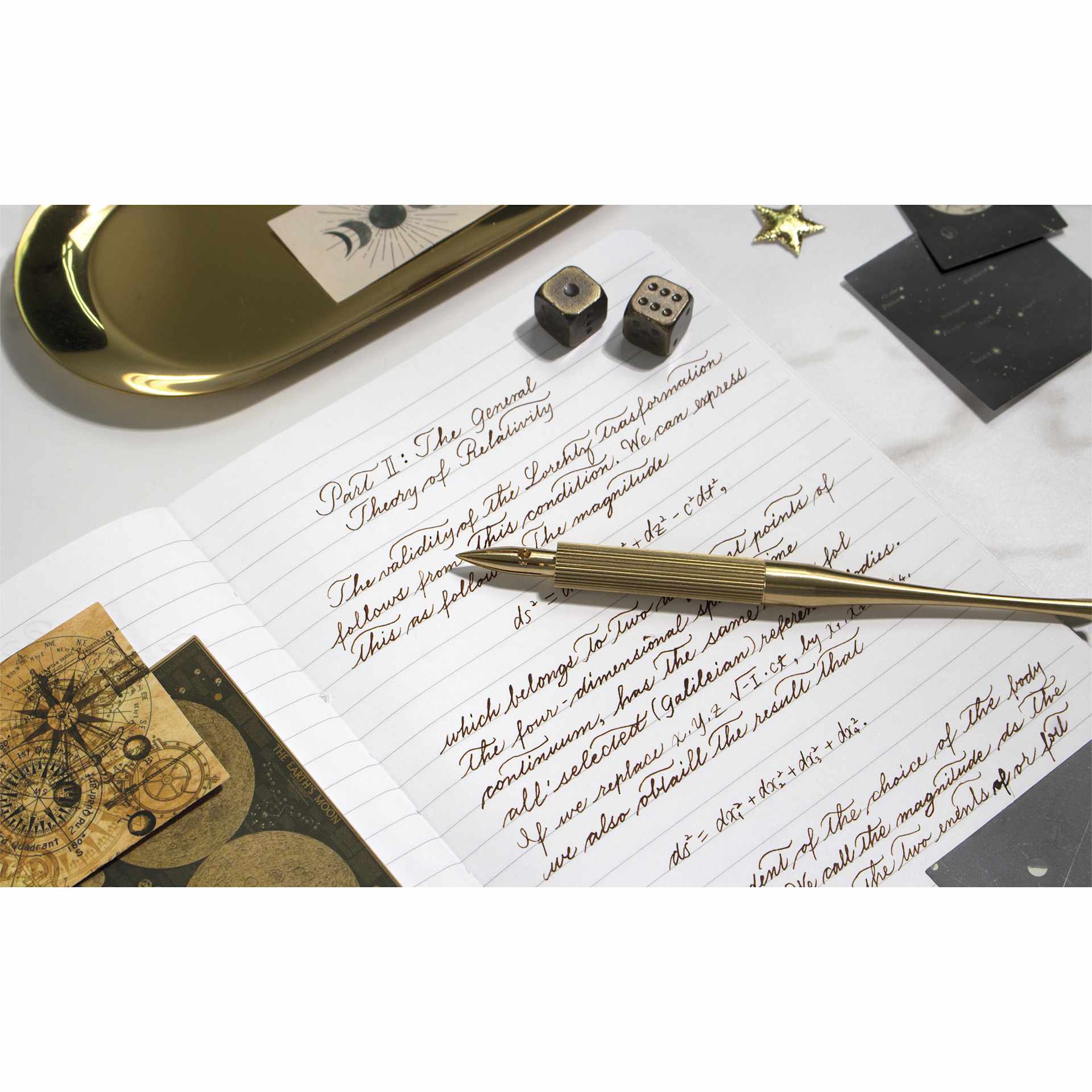 Colorverse Shuttle Nib Holder - Brass, Long, laid out on paper (nib not included)