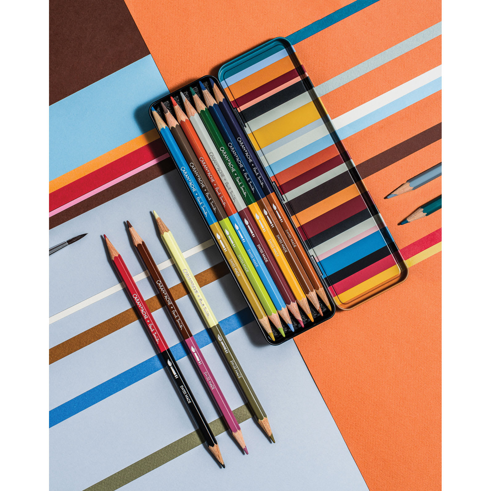 Caran d’Ache Paul Smith Special Edition Bicolor Water Soluble Colored Pencil Set, pencils in and out of packaging on tabletop
