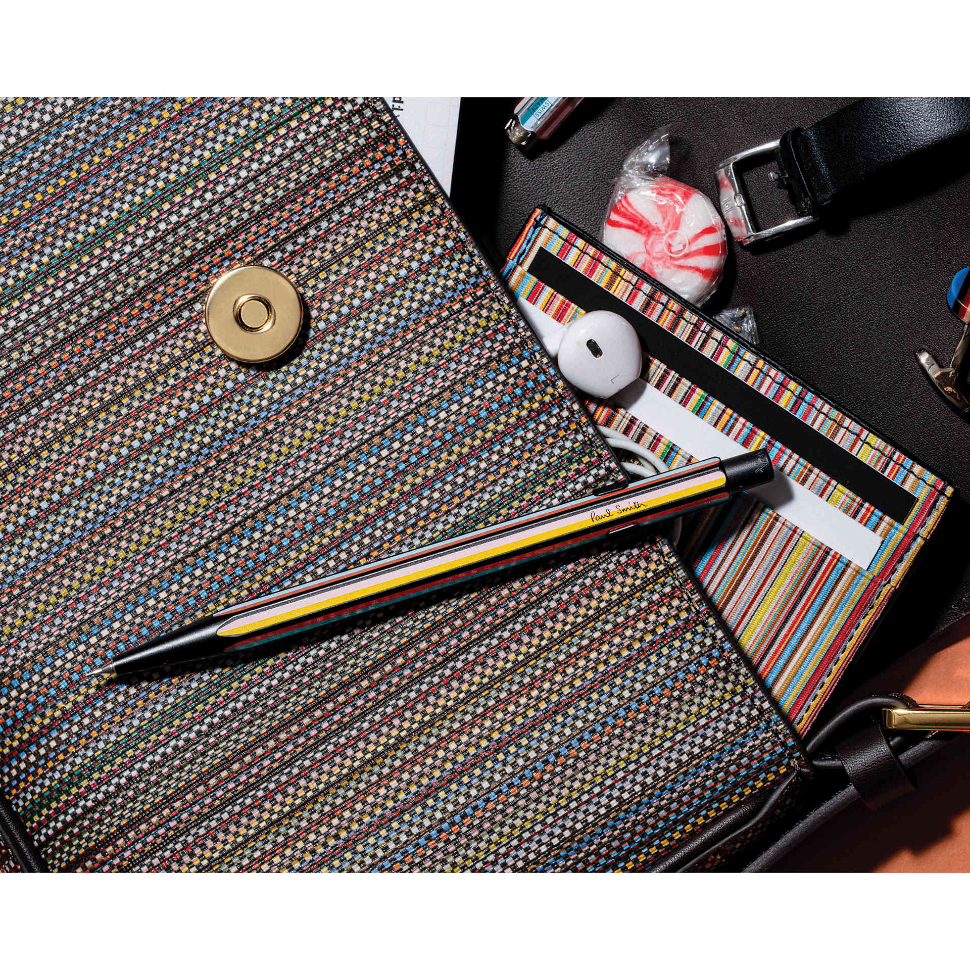 Caran d'Ache Paul Smith Special Edition 849 Mechanical Pencil - Satin Black, 0.5 mm, resting on bag
