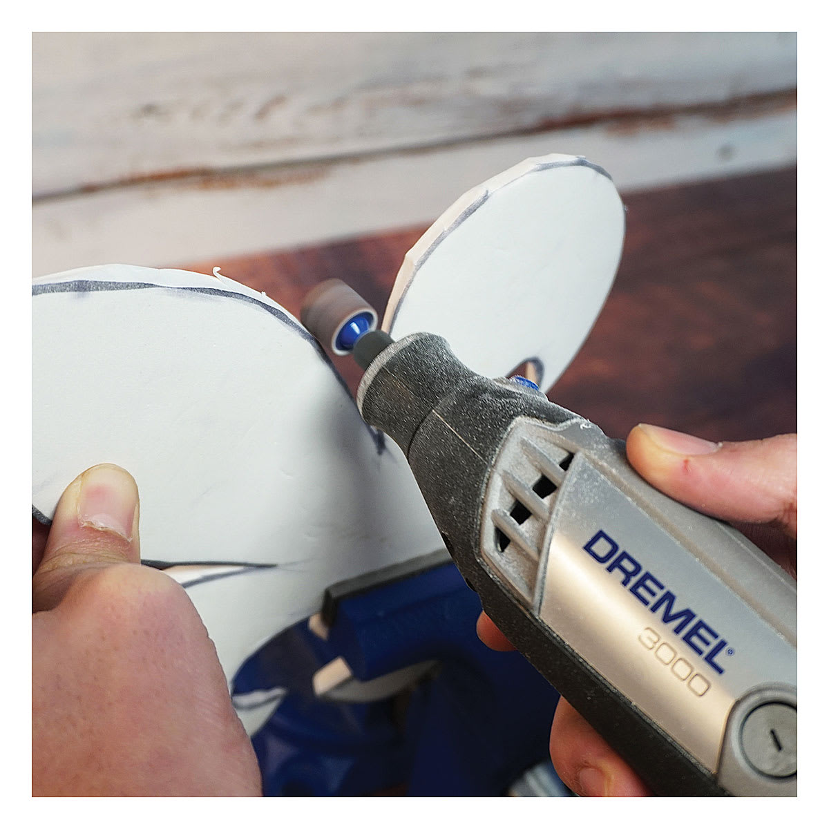 Dremel EZ Lock Accessory Kits - Hands using Grinding Accessory on plastic Butterfly shape
