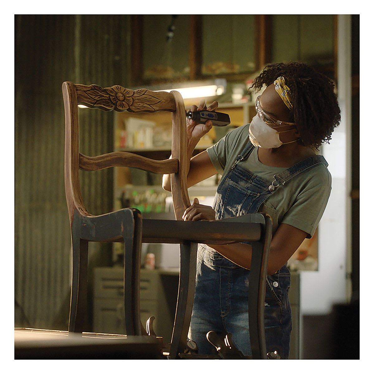 Dremel Lite Cordless Rotary Tool - Worker using Tool to strip carved wooden chair