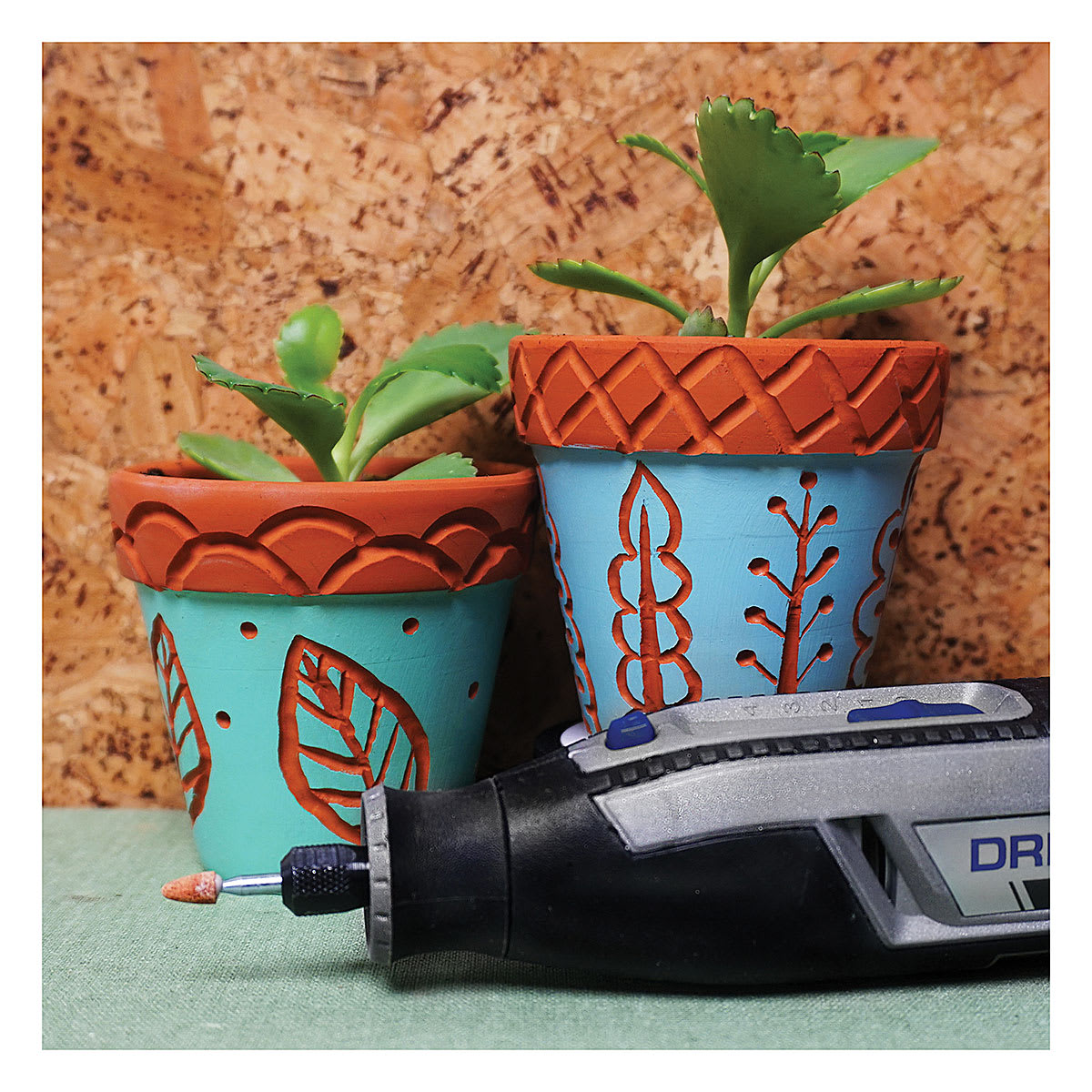 Dremel Lite Cordless Rotary Tool - Tool lying in front of carved decorated pots