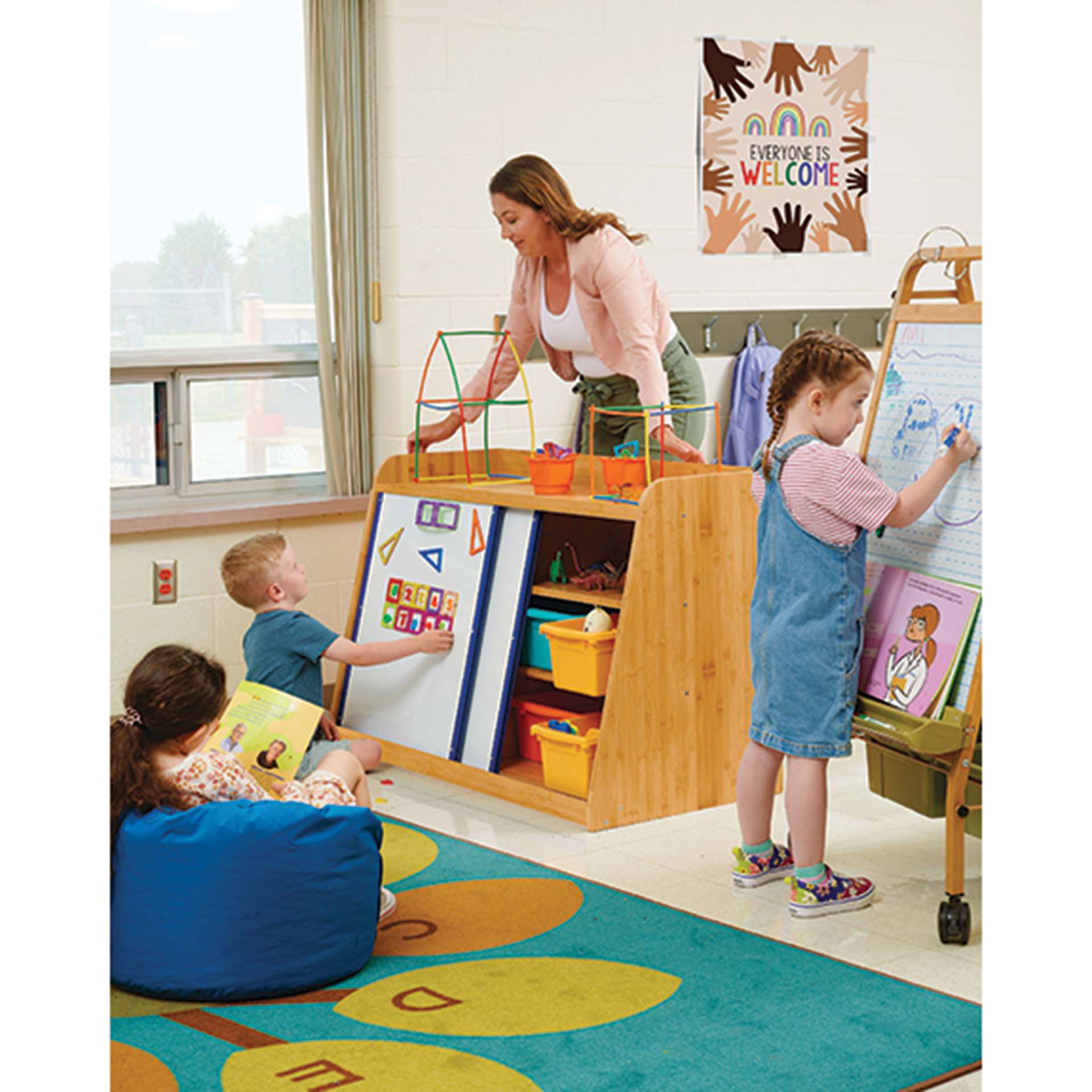Copernicus Bamboo Write and Store Shelf, showing Vibrant Tubs, child placing magnets (not included)