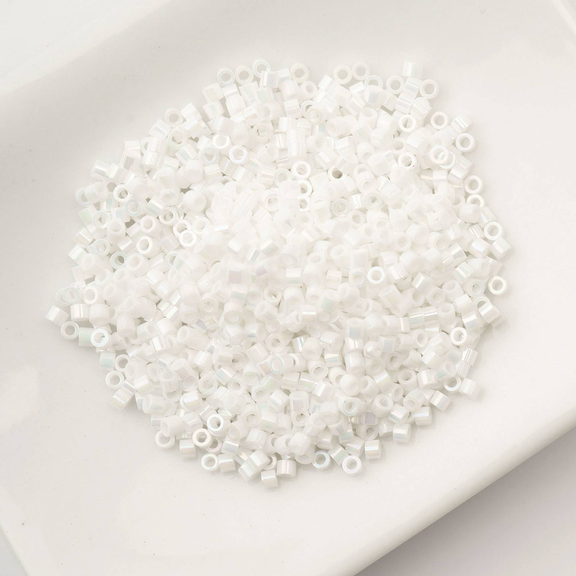 John Bead Cylin 11/0 Cylindrical Seed Beads - White Pearl AB sitting in dish