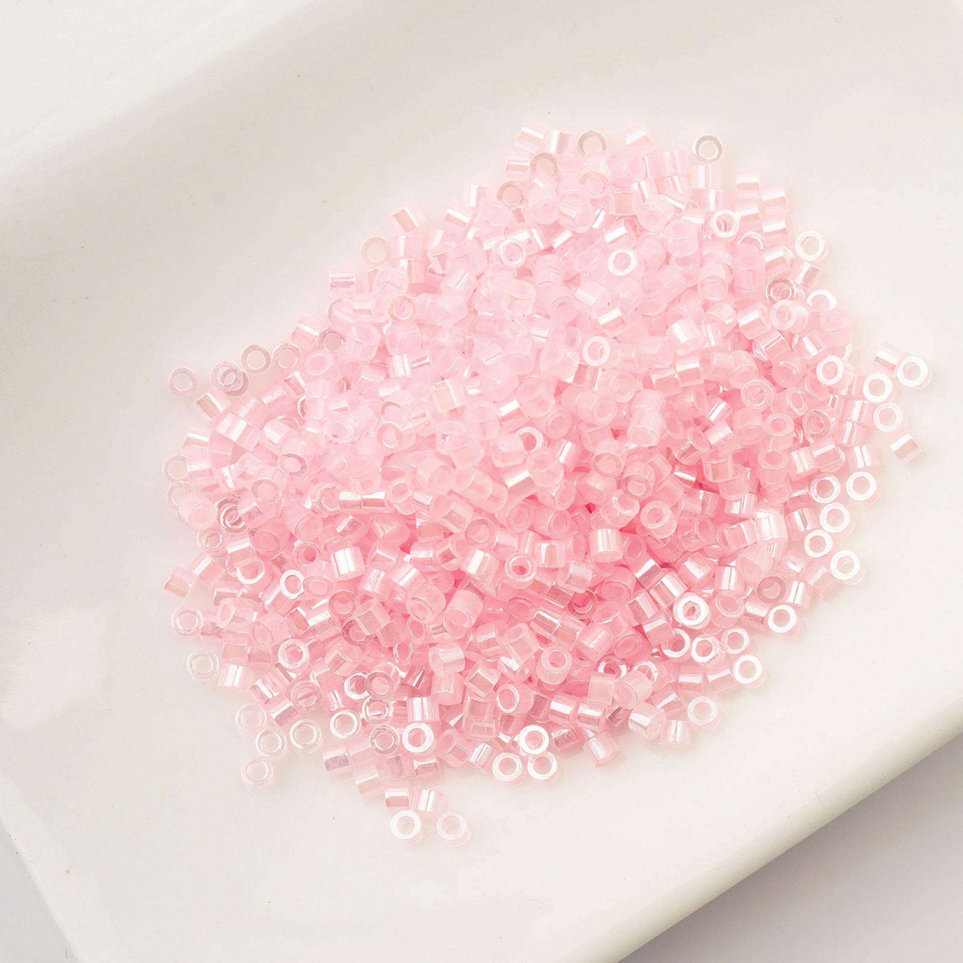 John Bead Cylin 11/0 Ceylon Cylindrical Seed Beads - Light Crystal Pink, 25g sitting in dish