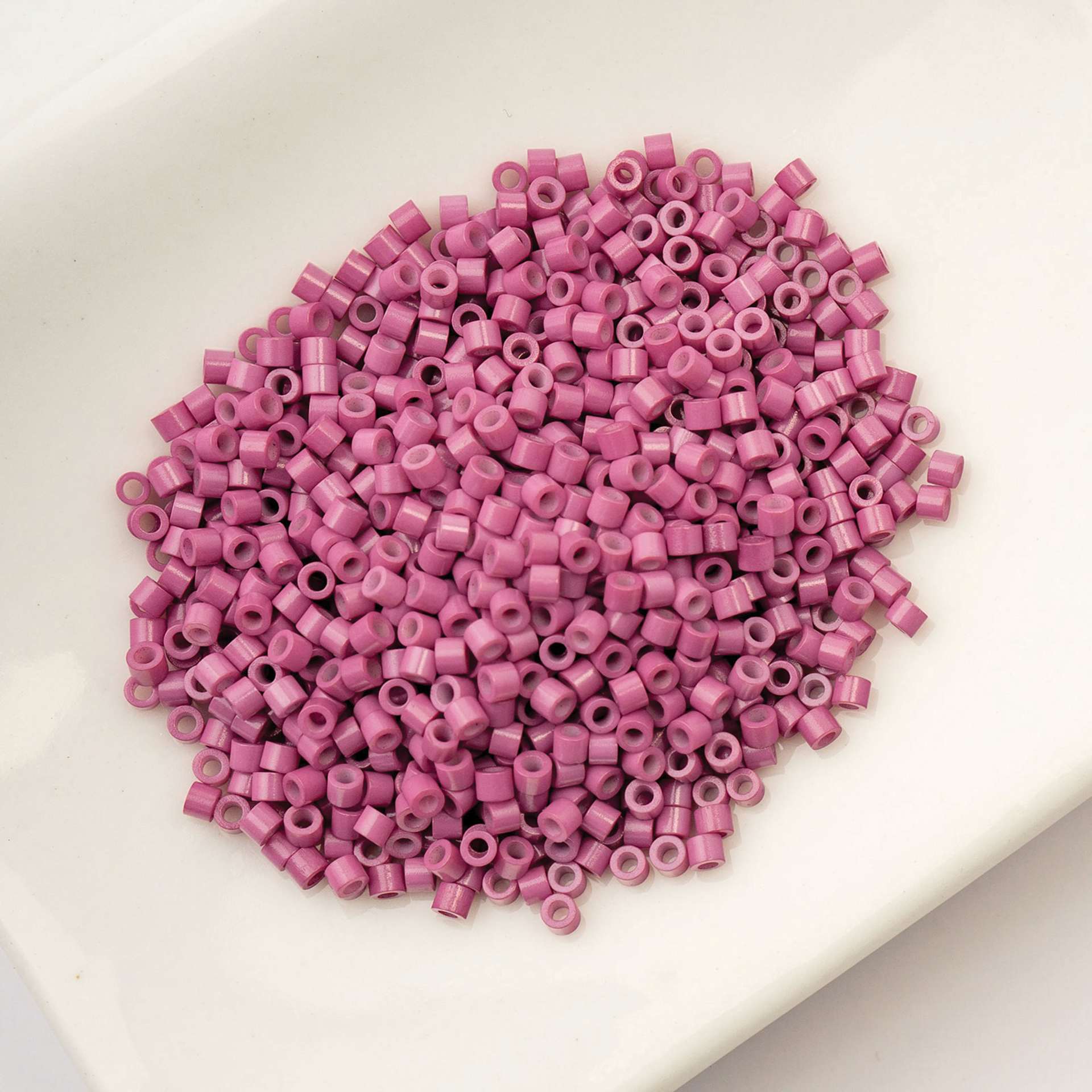 John Bead Cylin 11/0 Cylindrical Seed Beads - Vintage Rose Opaque sitting in dish