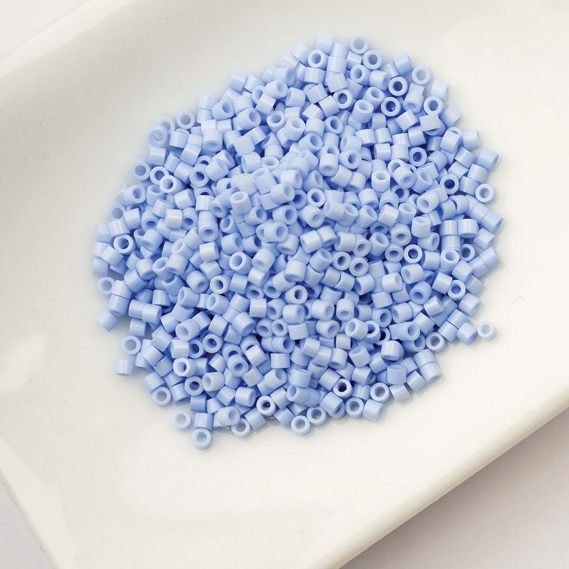 John Bead Cylin 11/0 Cylindrical Seed Beads - Bluebell Mist Opaque sitting in dish