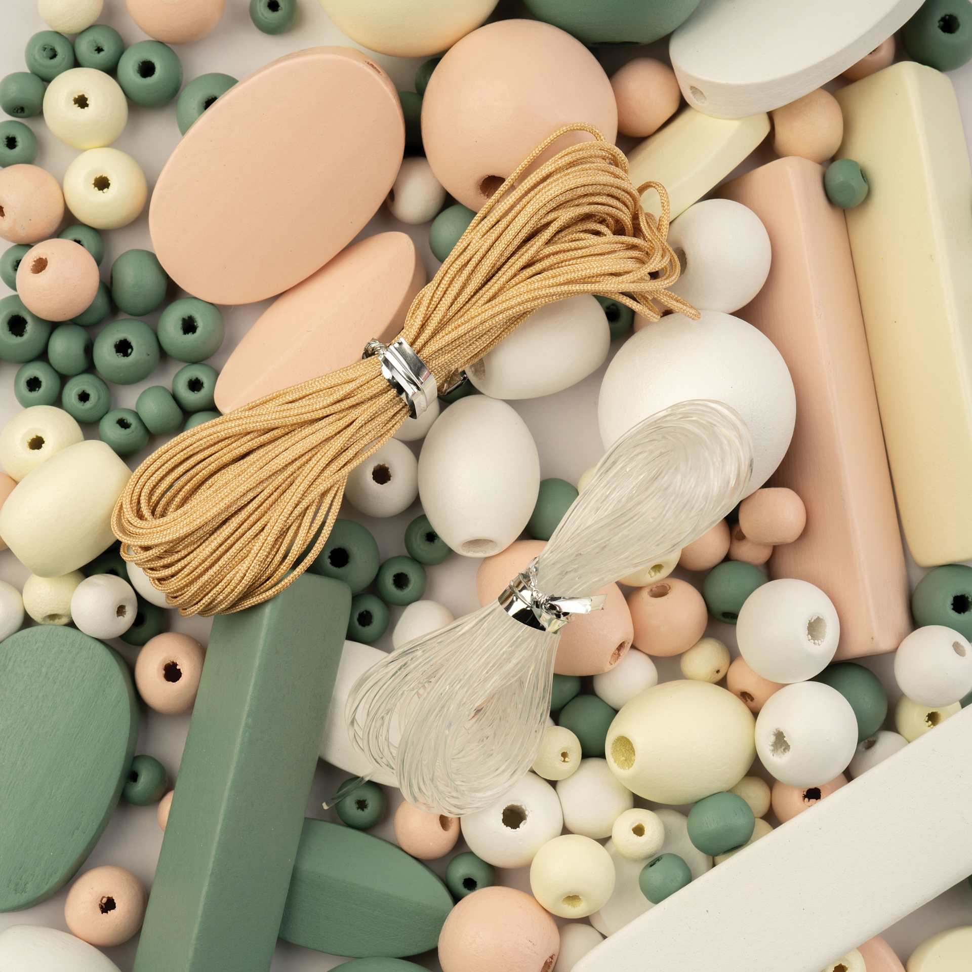 John Bead Wood Craft Beads - White, Cream, Light Peach, and Green, 90 g Bag showing included nylon cords