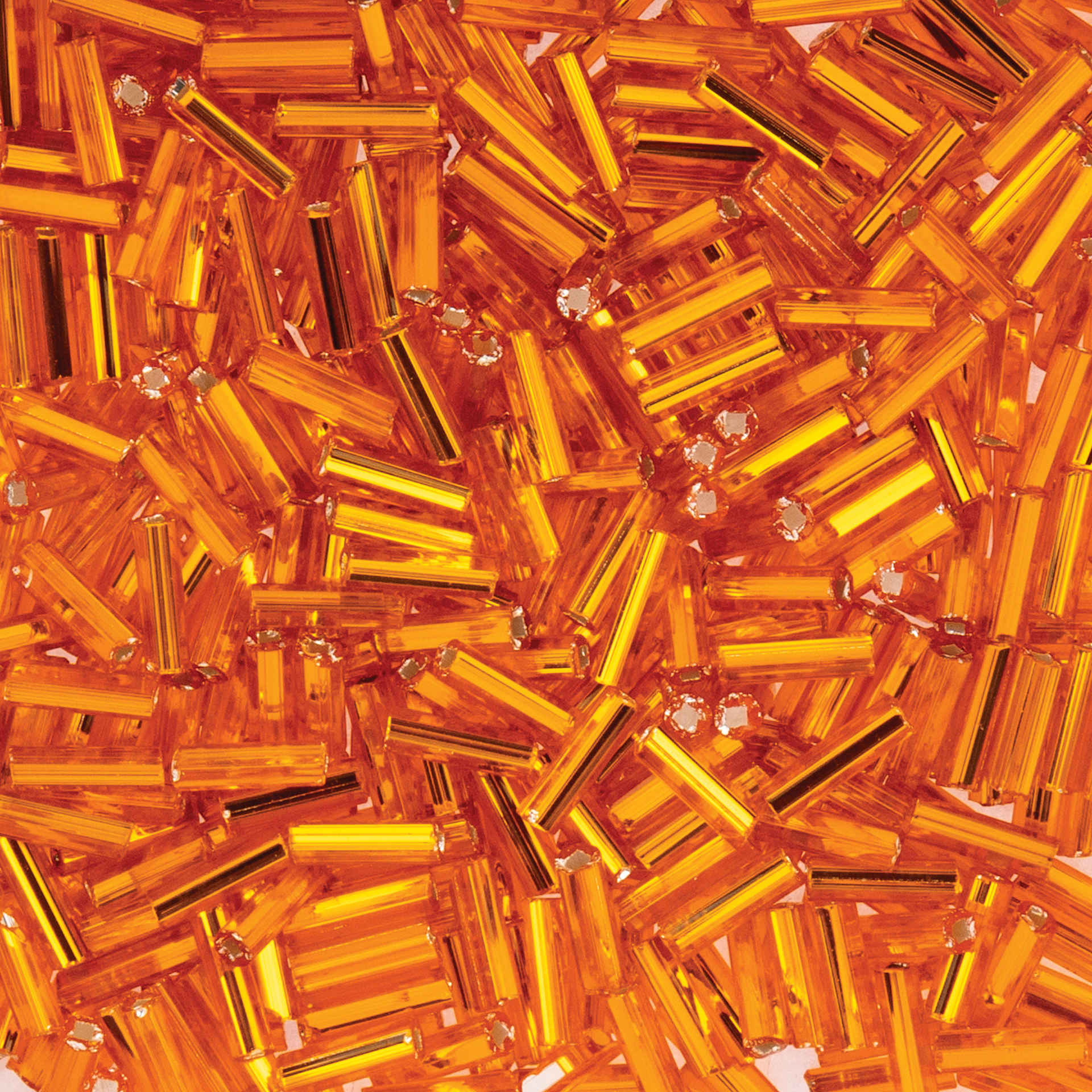 John Bead Czech Glass #3 Bugle Beads - Silver-Lined Light Orange close up