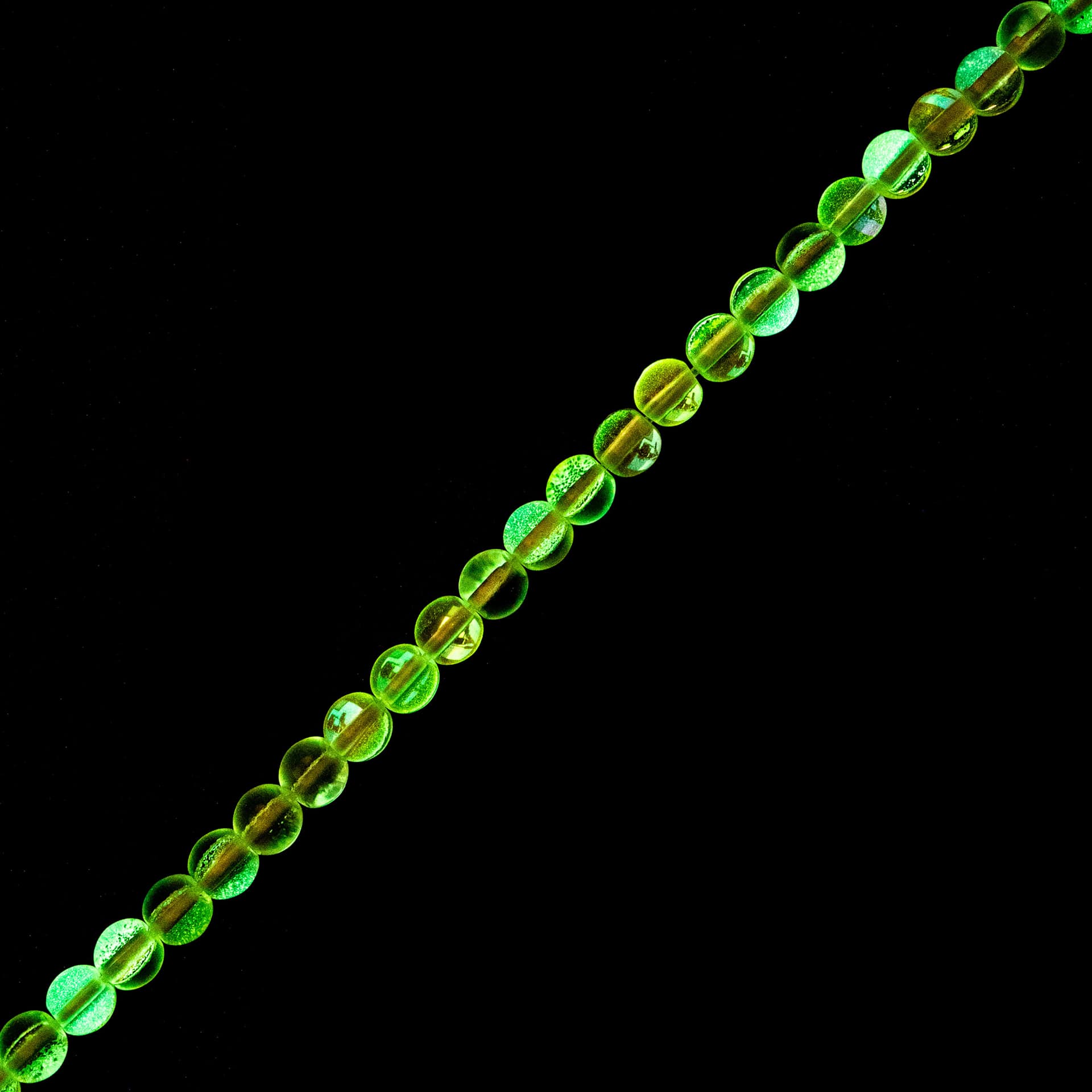 John Bead Crystal Lane DIY Glow in the Dark Round Bead Strand - Purple AB, 7 in showing glow effect