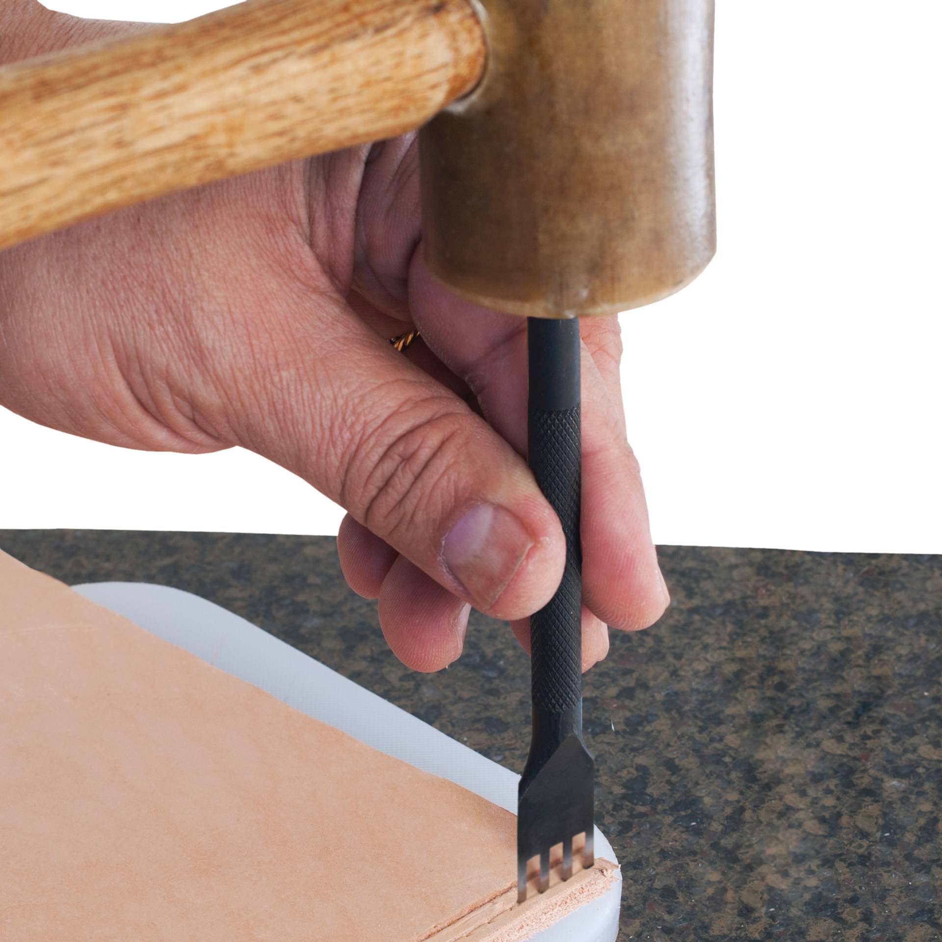 John Bead Metal Complex Leather Lacing Chisel - 4-Prong, Straight, 3.1 mm being used on leather with mallet