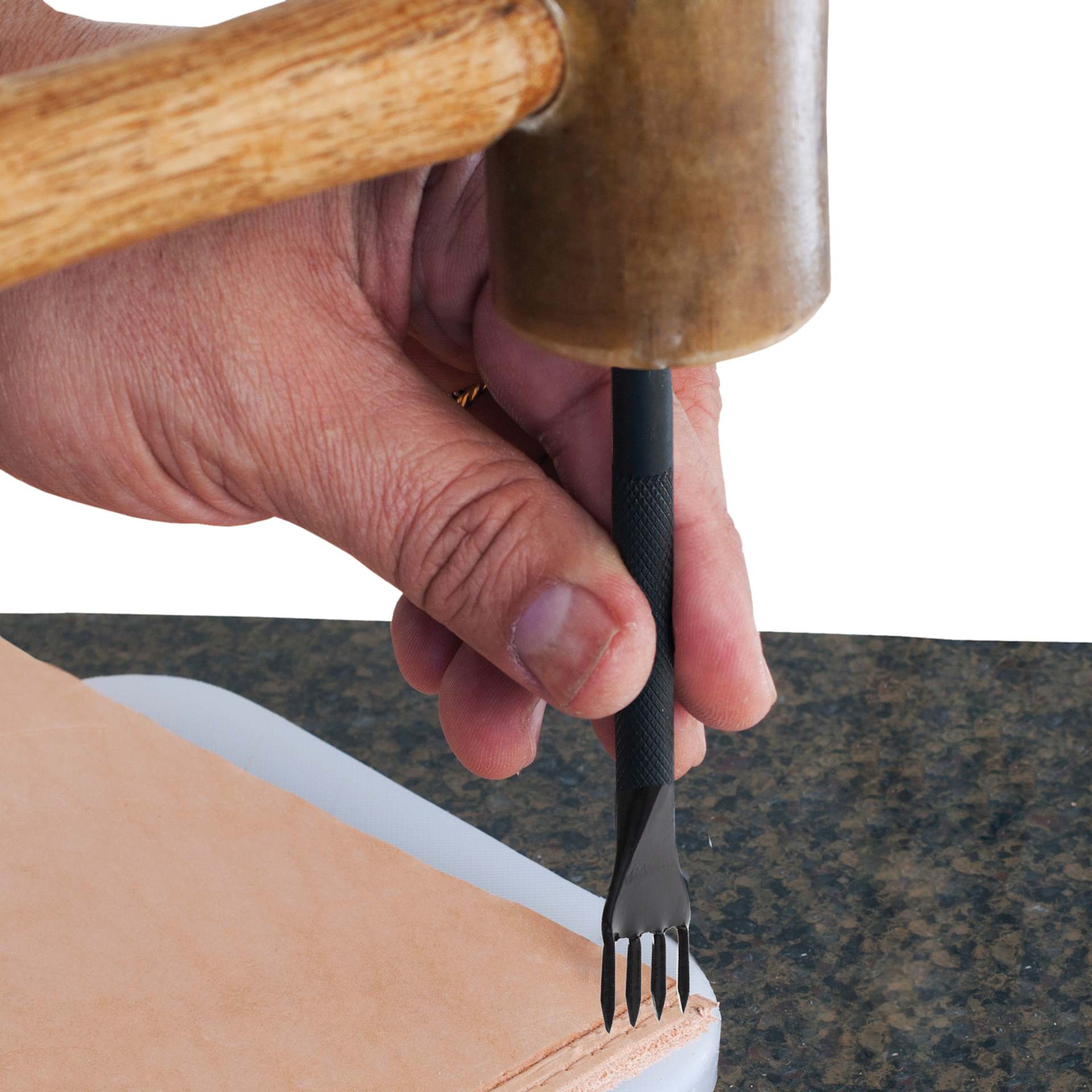 John Bead Metal Complex Leather Lacing Chisel - 4-Prong, Angled, 3.1 mm being used on leather with mallet