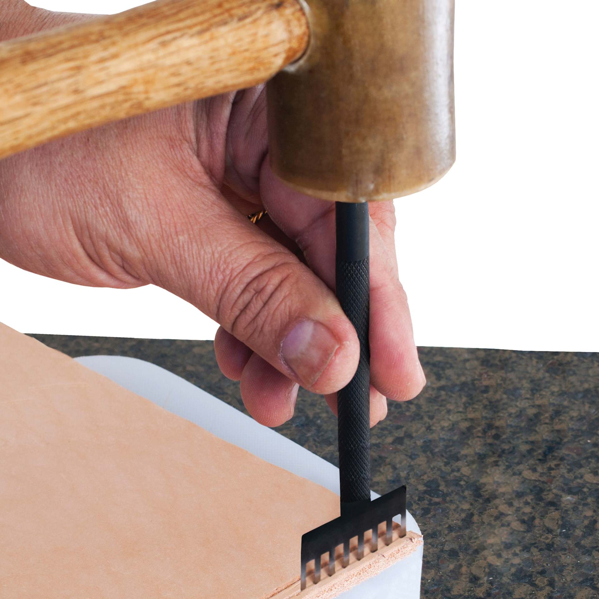 John Bead Metal Complex Leather Lacing Chisel - 8-Prong, Straight, 3.1 mm being used on leather with mallet