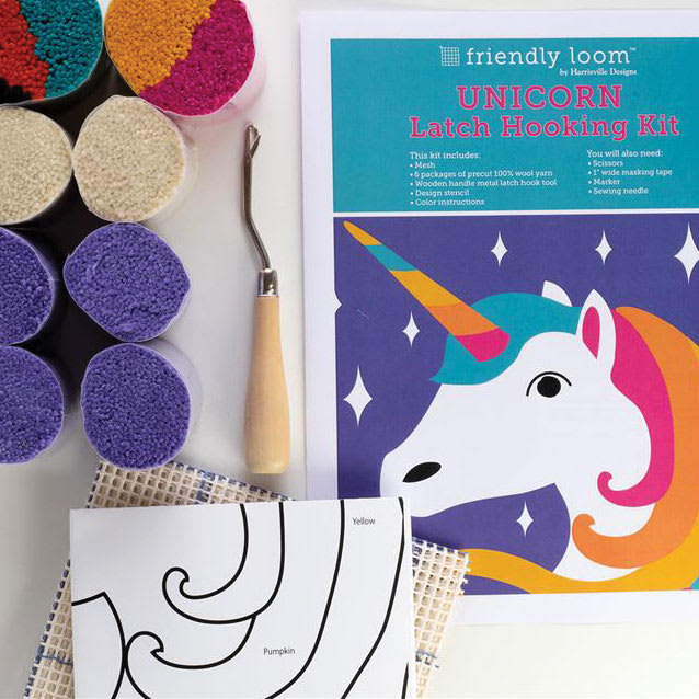 Friendly Loom Discover Latch Hooking Kit - Unicorn contents laying on table