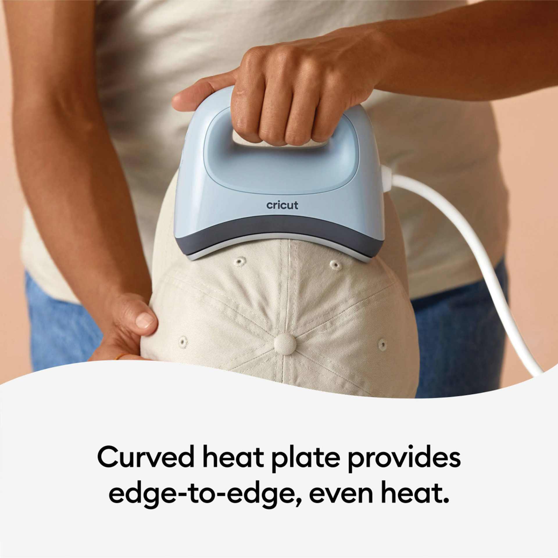 Cricut Hat Press (person using the press on a hat)