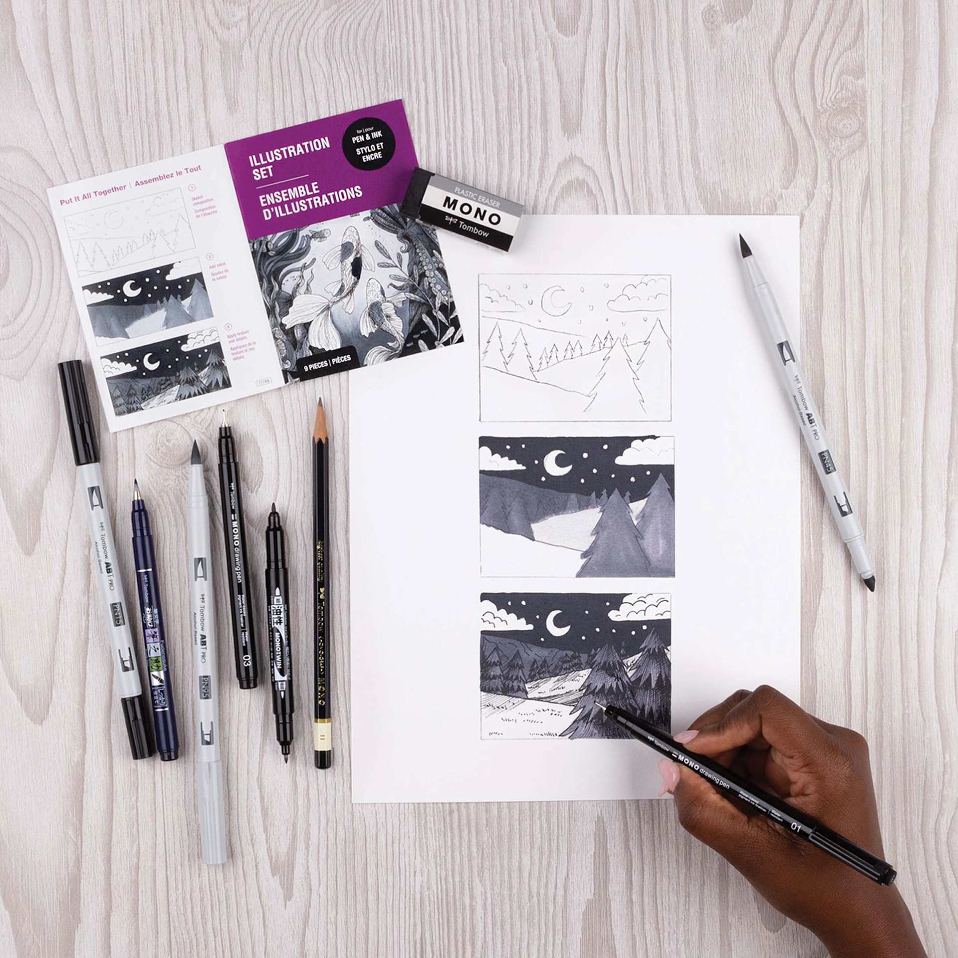 Tombow Illustration Set, contents laid out next to illustration and drawing pen in hand Tombow Illustration Set, contents laid out next to illustration and drawing pen in hand