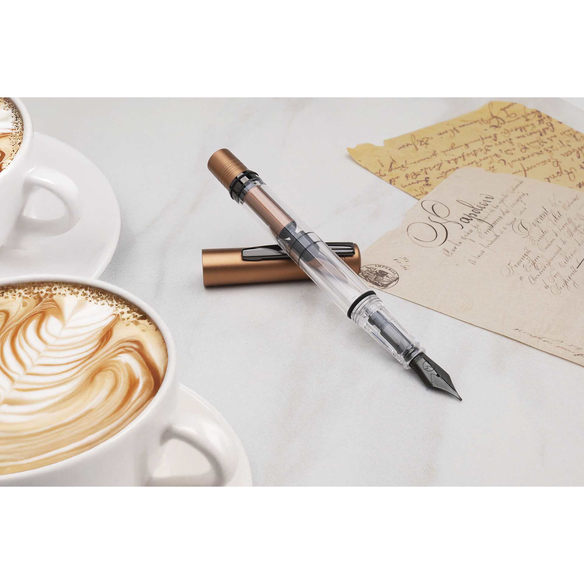 Monteverde MP1 Fountain Pen - Mocha Mousse, Fine Nib, propped up near mocha drink and notes