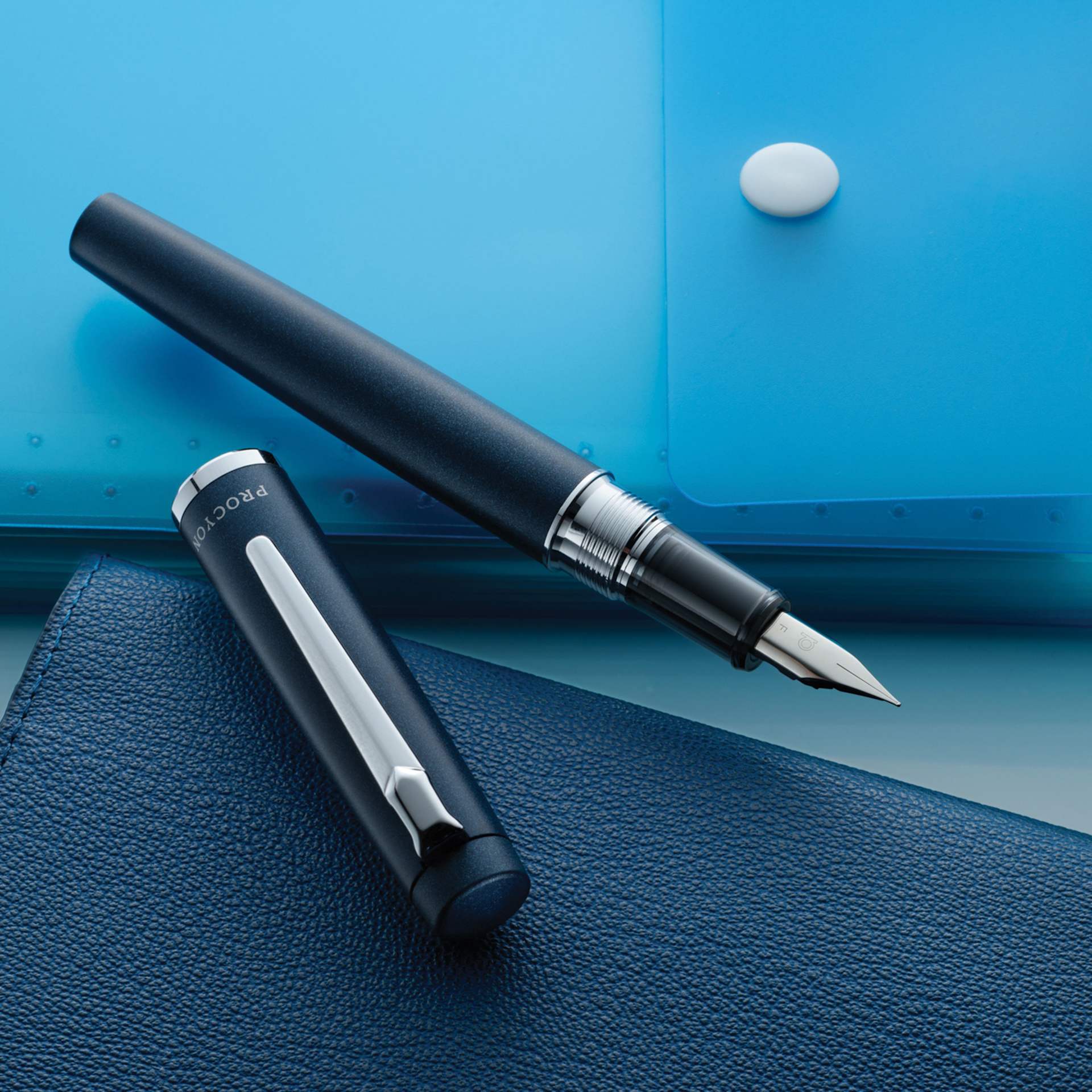 Platinum Procyon Fountain Pen - Deep Sea Blue, Medium Nib, pen and cap with stationary (image may depict a different nib size)