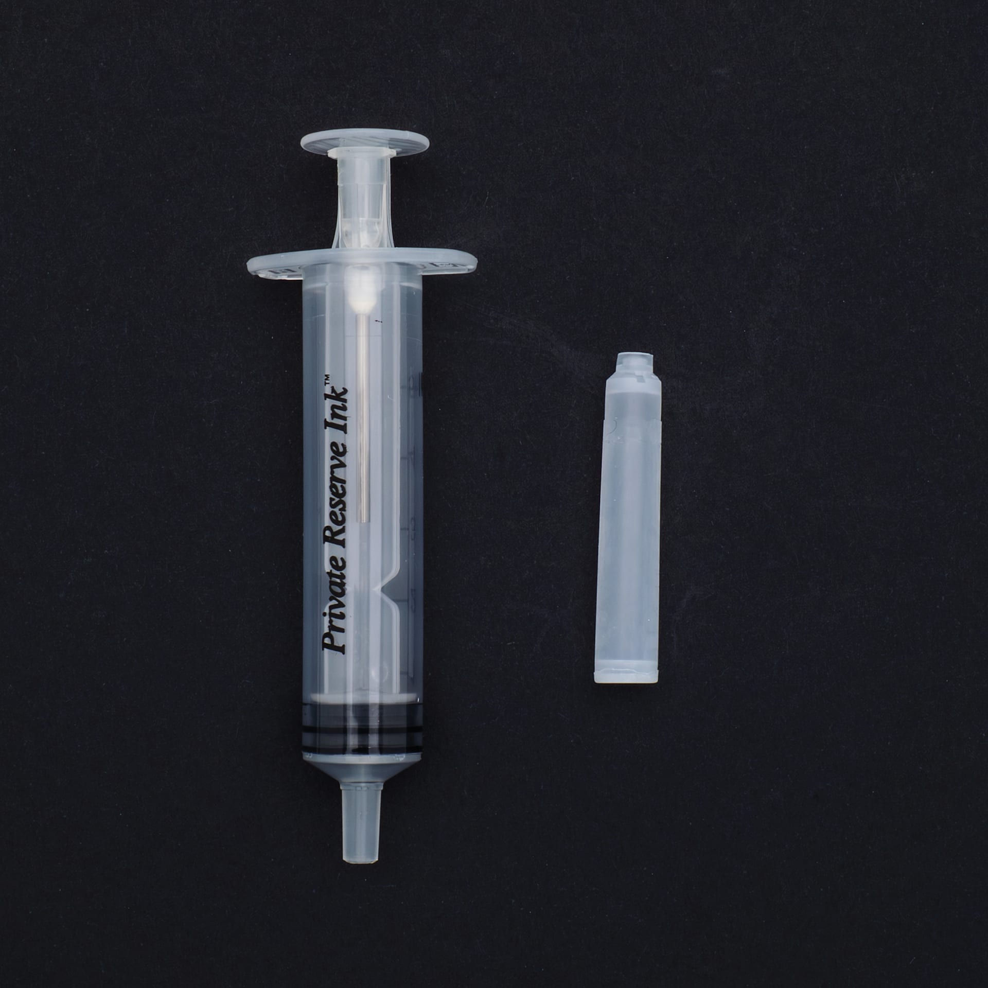 Private Reserve Ink Essentials Standard Kit 1, single syringe and cartridge against black background