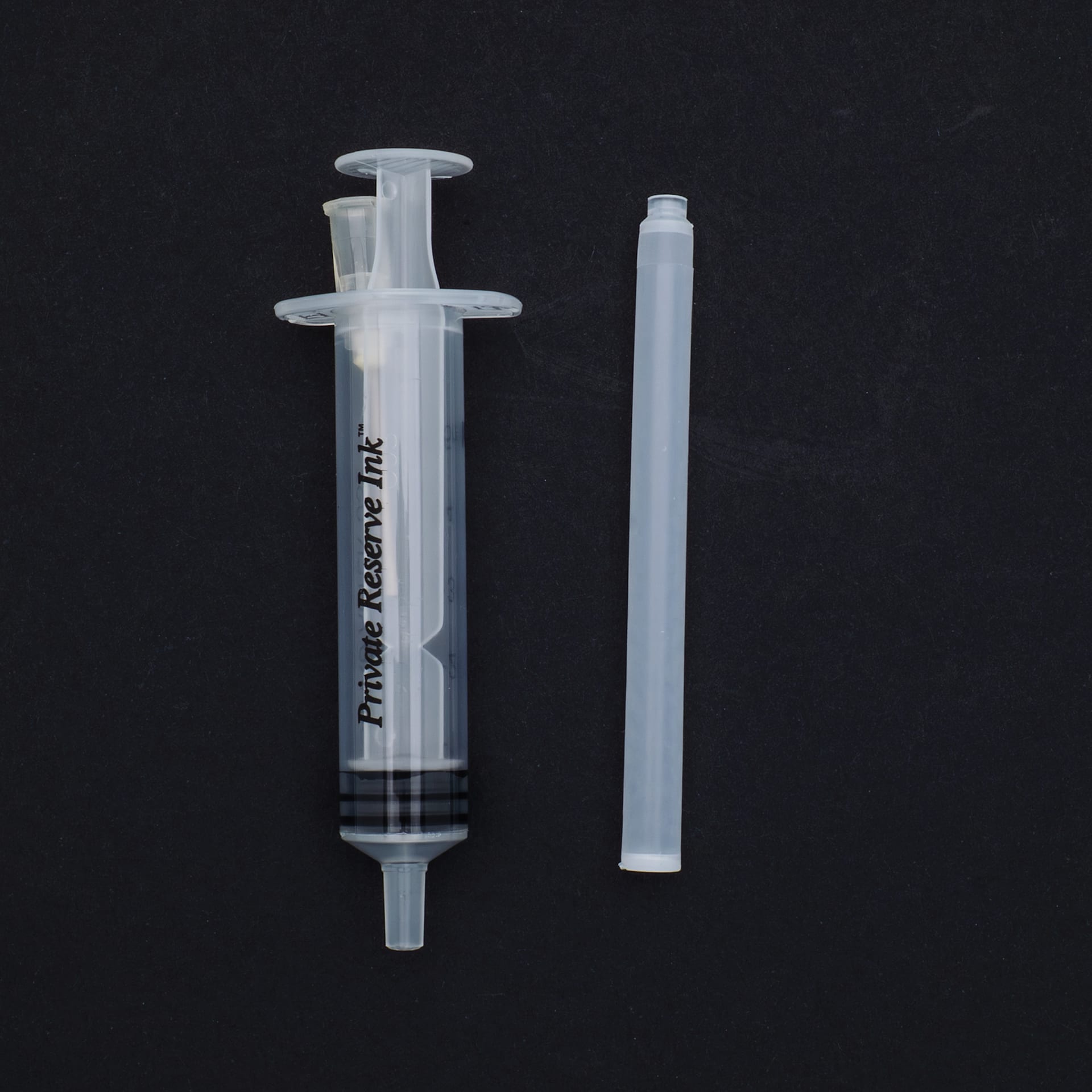 Private Reserve Ink Essentials Long/Magnum Kit 2, a syringe and cartridge against a black background
