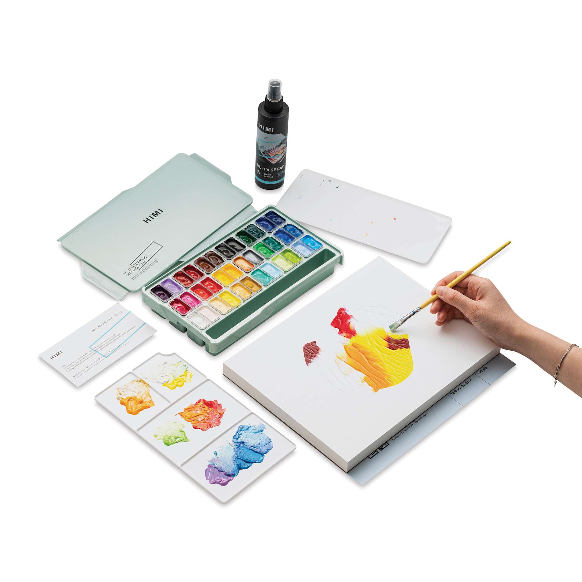 A person using the Himi Jelly Acrylic Paints to paint on paper.
