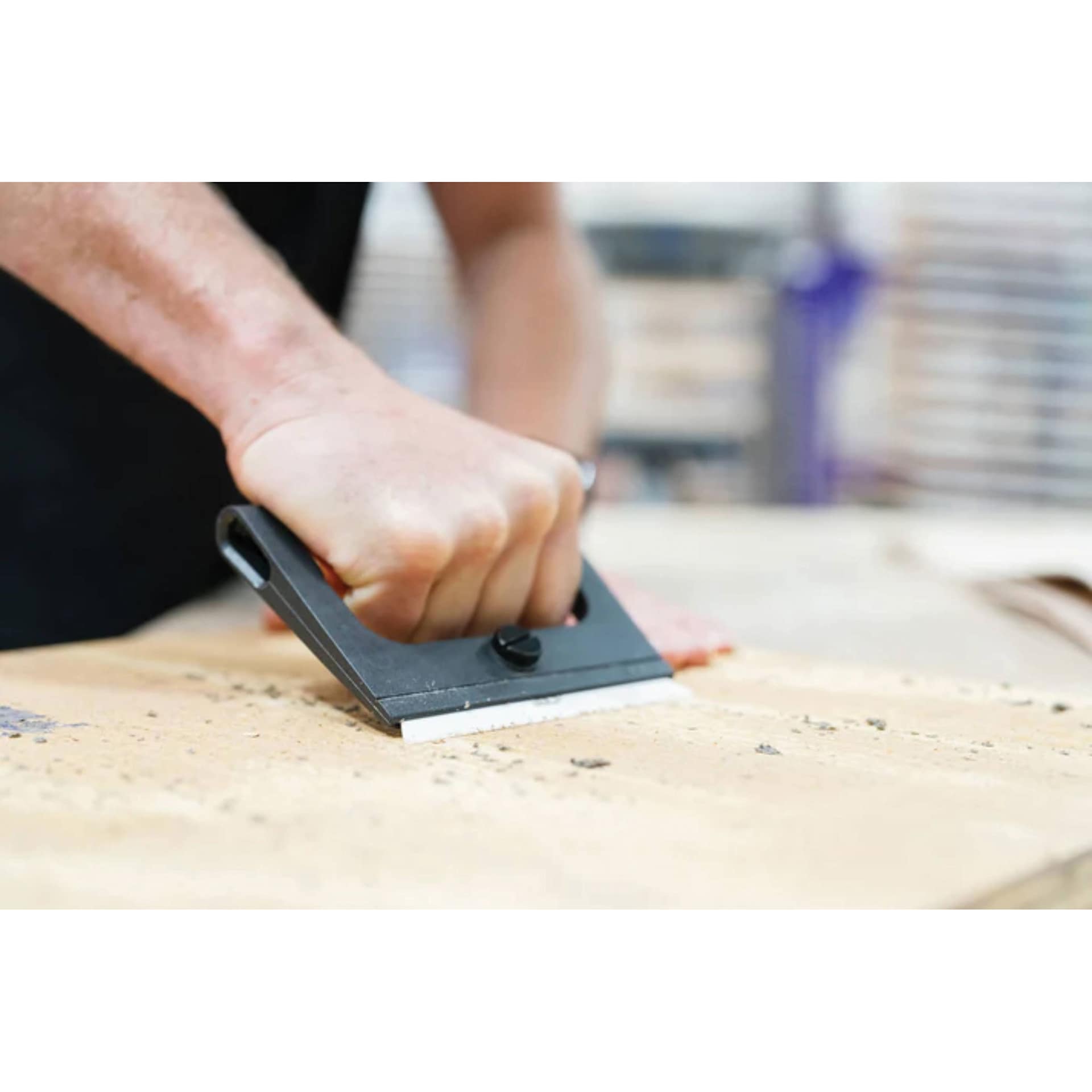 Slice Wide-Grip Scraper, hand pushing scrapper against wood surface