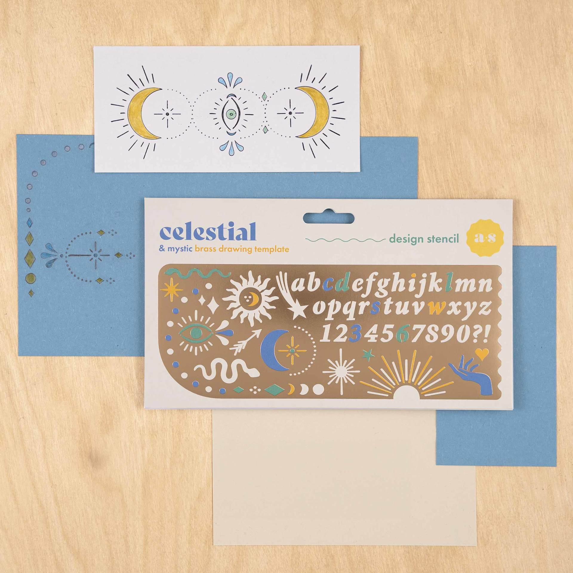 Another Studio Brass Stencil - Celestial, stencil in packaging with stenciled paper