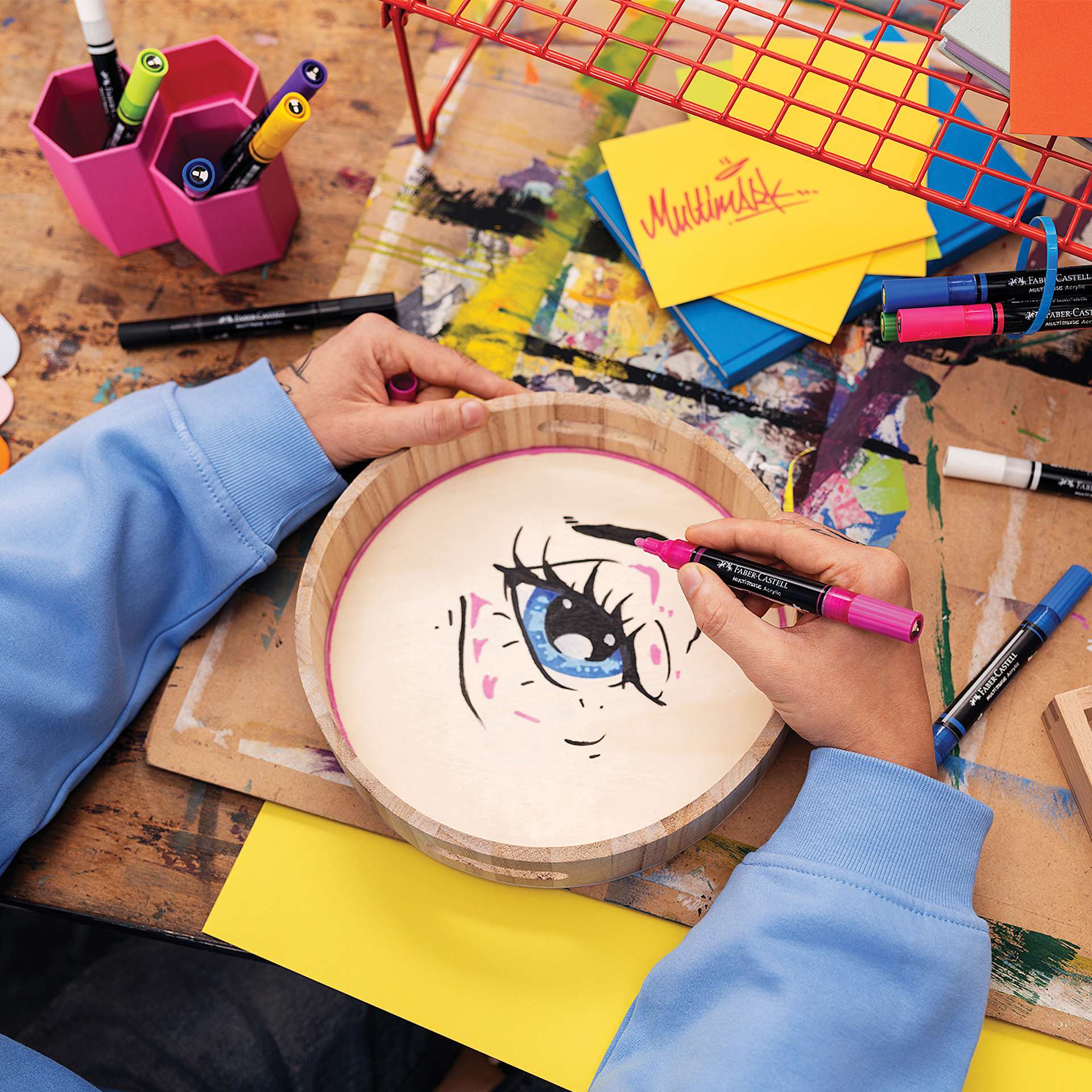 Faber-Castell Multimark Dual-Tip Acrylic Markers, sketching an eye on a wooden basket.