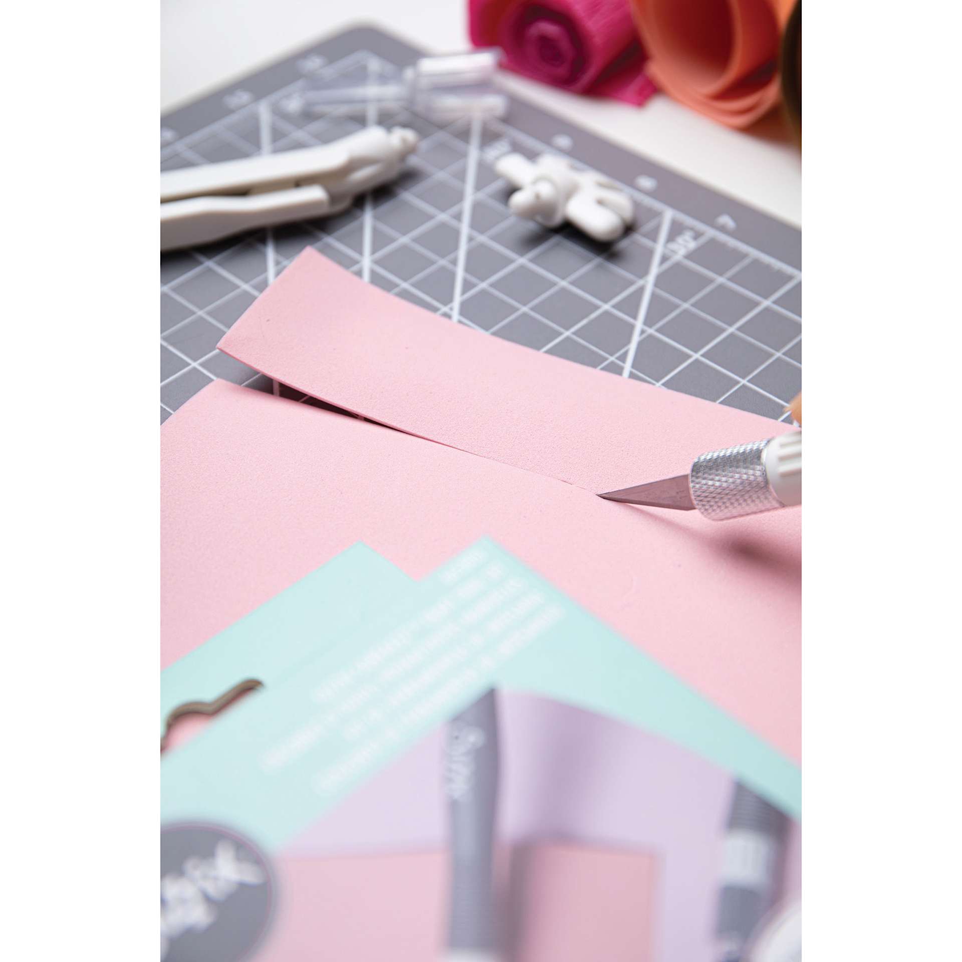Sizzix Making Tool Surfacez Set, tool in hand slicing paper with craft knife top