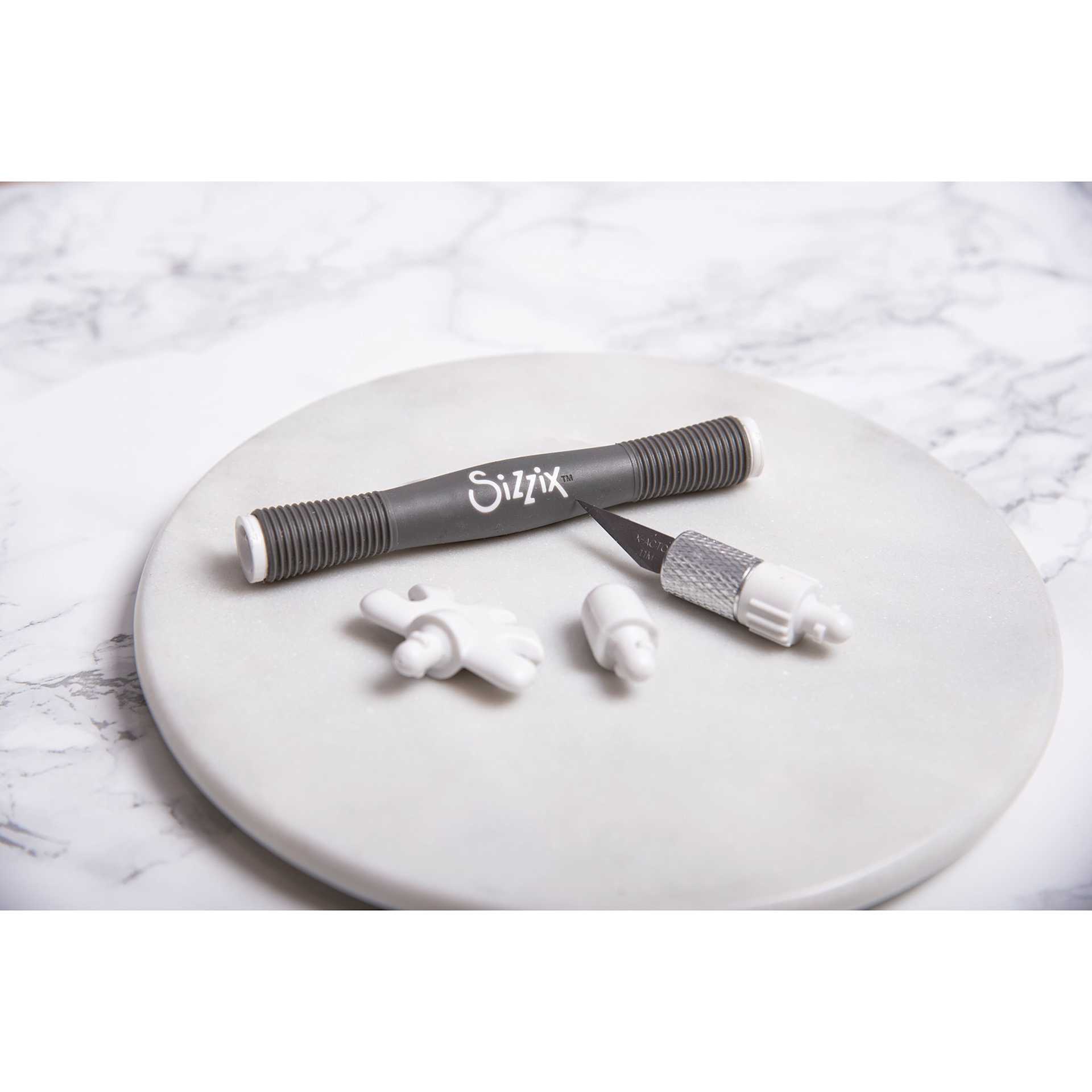 Sizzix Making Tool Surfacez Set, contents laid out on a round surface