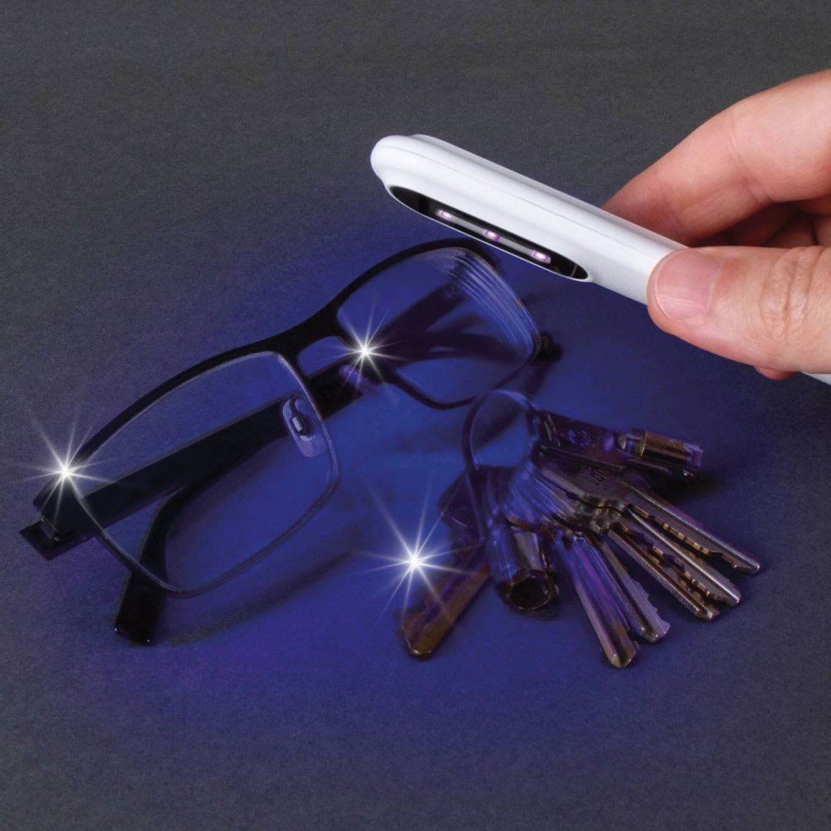 OttLite Compact Travel UVC Disinfecting Wand (Person disinfecting eyeglasses and keys)