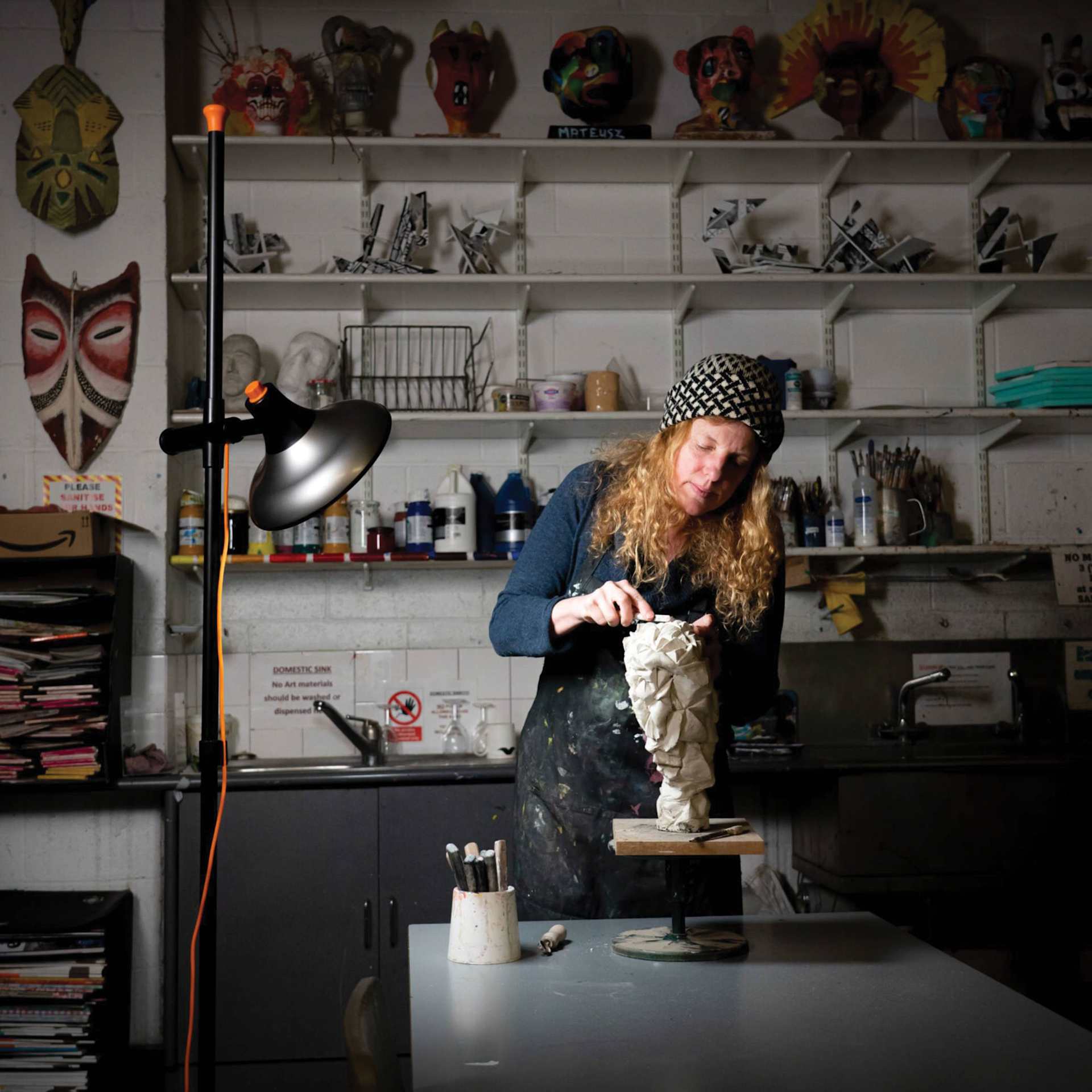 Daylight Artist Studio Lamp 2 with Stand - Chrome and Black in use in sculpting studio