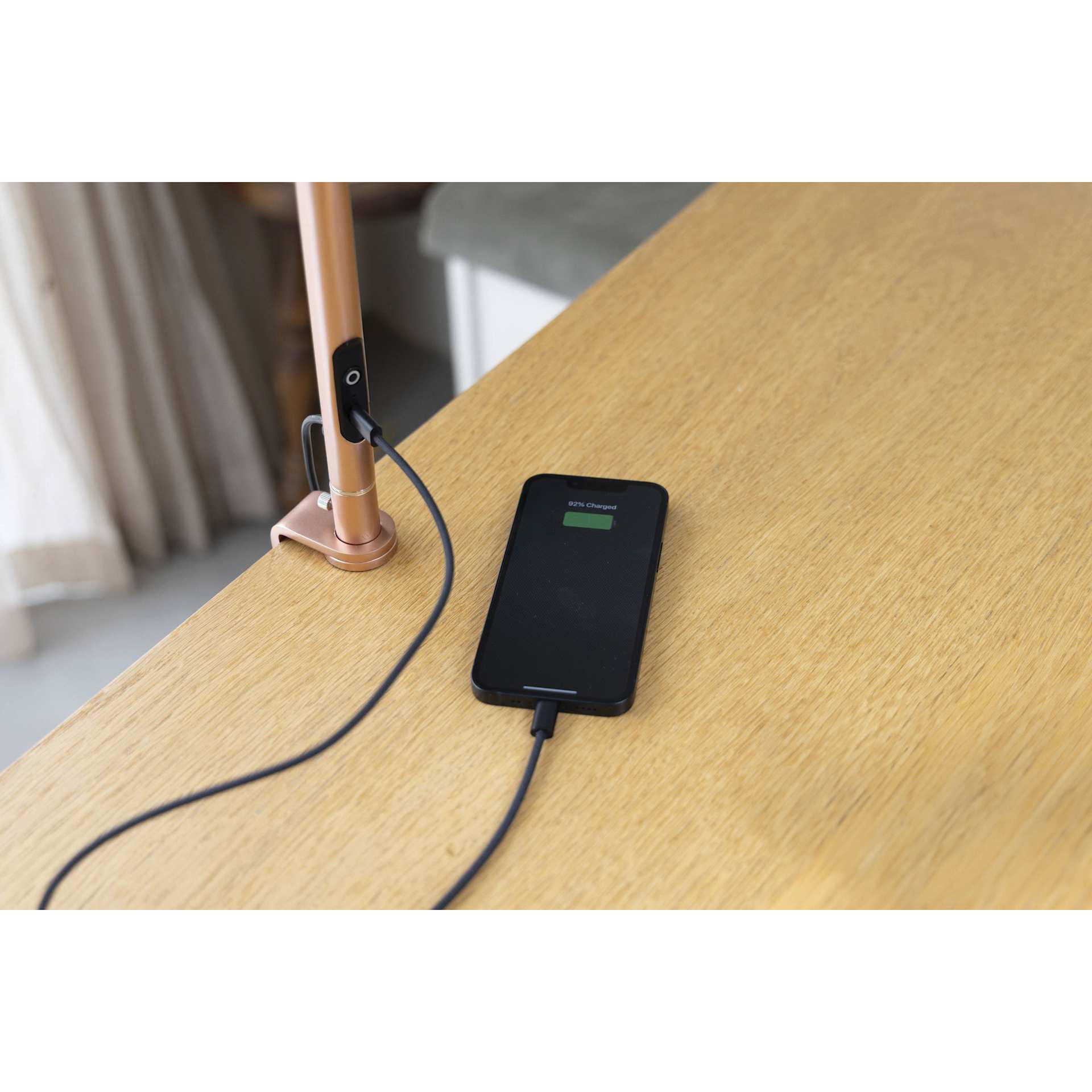 Daylight Slimline 4 LED Table Lamp - Rose Gold - demonstrating device charging capability