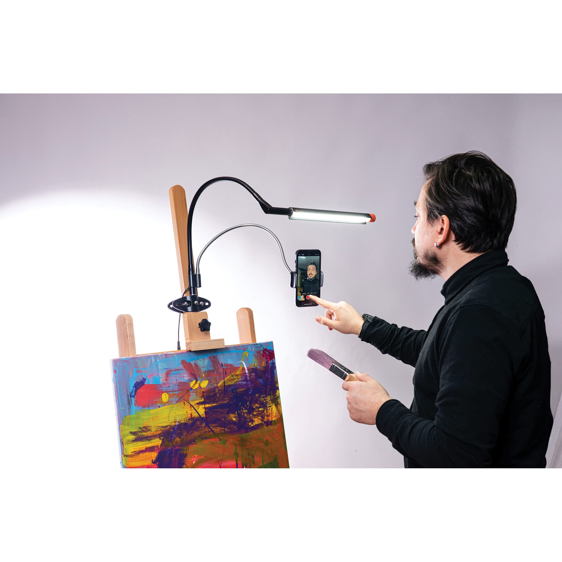 Daylight Flexi Phone Holder - attached to a light on an easel