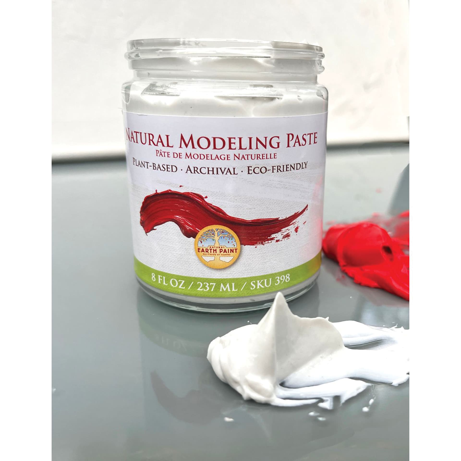 Natural Earth Paint Natural Acrylik Modeling Paste jar open with modeling paste holding a peak