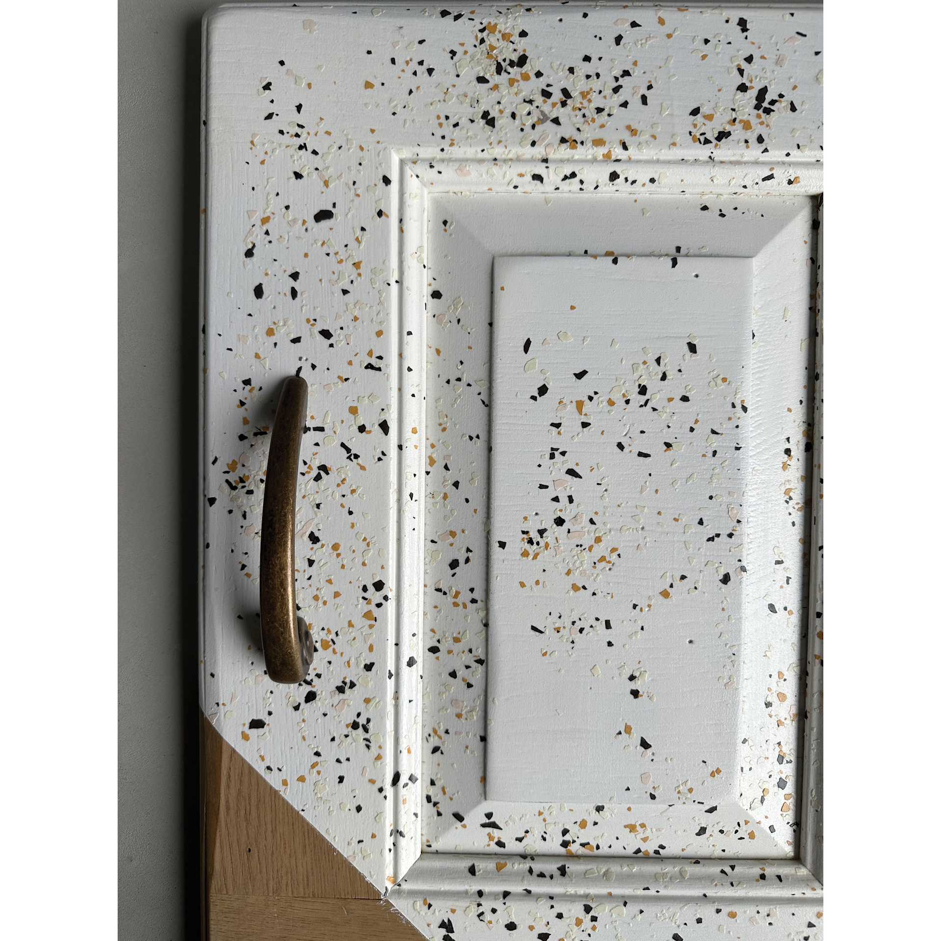 Fleur Terrazzo Effect Flakes used in a paint medium to decorate a cabinet door.