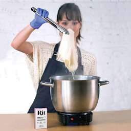 Rit Color Remover - Model removing fabric from Color Remover solution with tongs