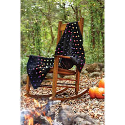 Premier Yarn Sweet Roll Vivid, throw blanket on top of wooden chair