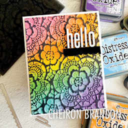 Sizzix Multi Level Textured Impressions Embossing Folder - Vault Lace, 4-1/2" x 6-1/2" showing rainbow-colored completed project by Cheiron Brandon