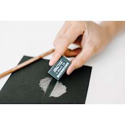General's Factis Magic Black Eraser -Hand using eraser to remove white shading from black paper