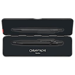 Caran d'Ache 849 Black Code XL Ballpoint Pen - Black, shown inside of the metal case