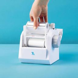 Xyron Create-A-Sticker Mini Permanent Refill Cartridge, refill being loaded into sticker maker