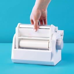 Xyron Create-A-Sticker Permanent Refill Cartridge being placed in Xyron Create-A-Sticker Sticker Maker (sold separately)
