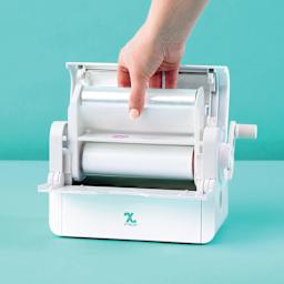 Xyron Creative Station Lite Laminated Adhesive Refill Cartridge being inserted