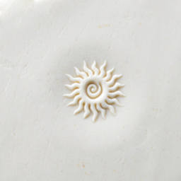 MKM Pottery Tools Curve Top Stamp - Spiral Sun - stamped into clay