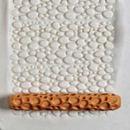 MKM Pottery Tools Hand Roller - Cobbles applied to clay