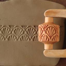 MKM Pottery Tools Medium Handle Roller - Art Nouveau being applied to clay