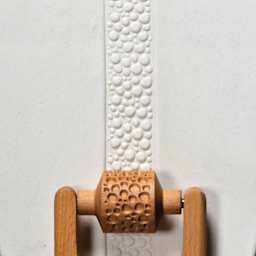 MKM Pottery Tools Medium Handle Roller - Cobbles applied to clay
