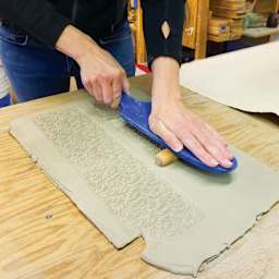 MKM Pottery Tools Roller Board being used to apply roller to clay